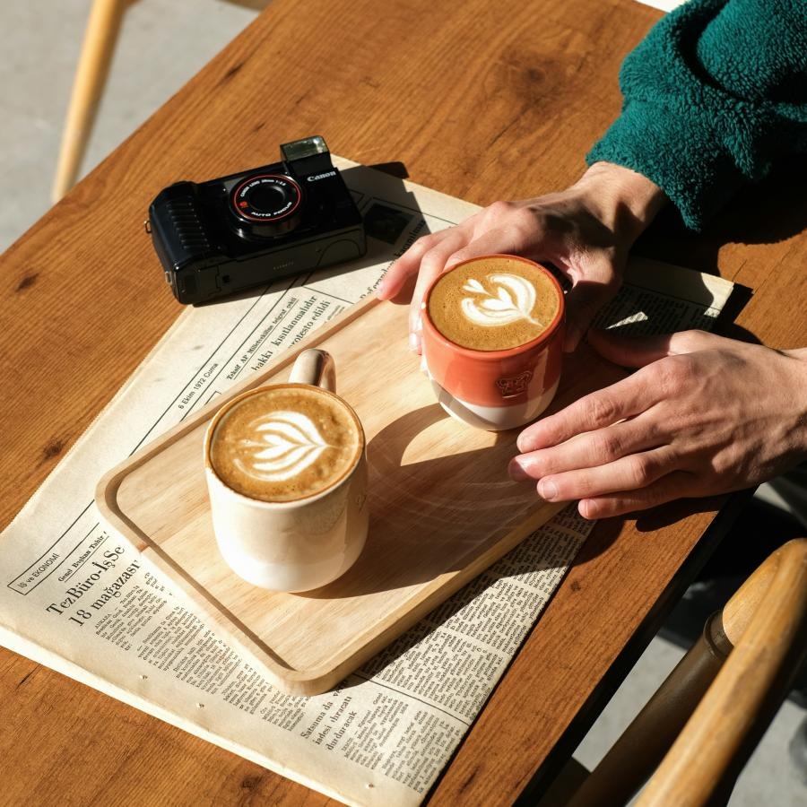 a person reaching for a cup of coffee